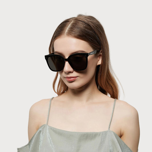 Model wearing Celeste Black square sunglasses, angled view