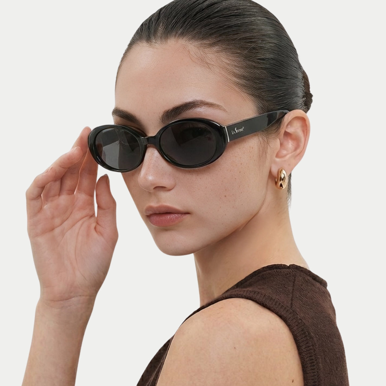 Model adjusting Riva Black oval polarized sunglasses