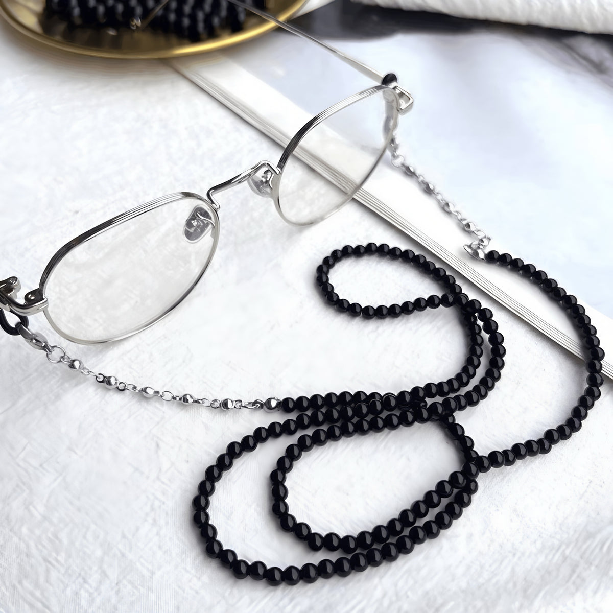 Black beaded eyeglass chain attached to eyeglasses, product view