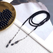Black beaded eyeglass chain with silver-tone links and adjustable end loops, product view