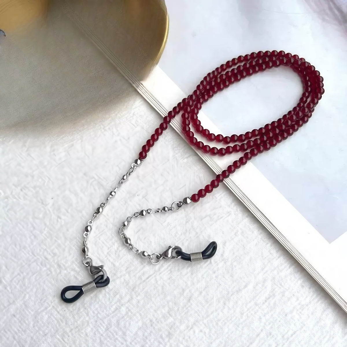 Burgundy beaded eyeglass chain with silver-toned links, product view