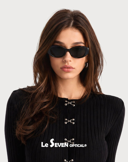 Model wearing Bella Black oval polarized sunglasses, front portrait