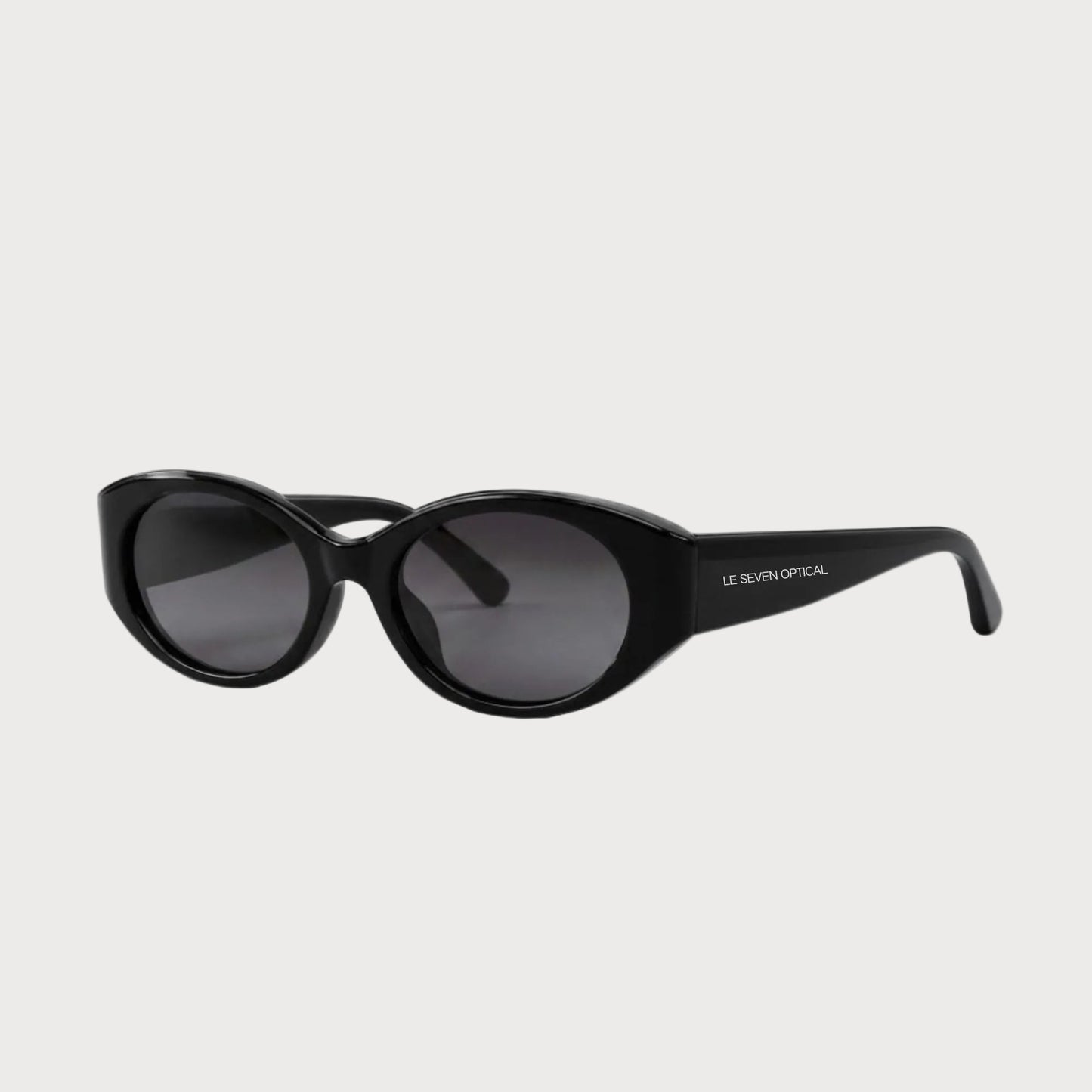 Bella Black oval polarized sunglasses, three-quarter front-side product view on light gray