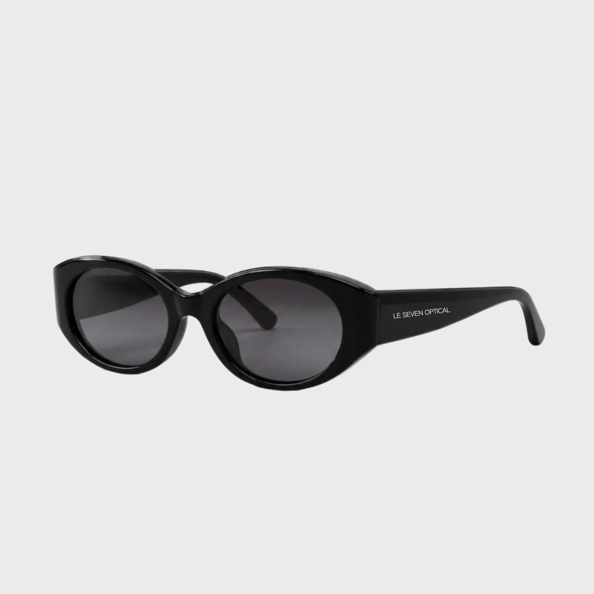 Bella Black oval polarized sunglasses, three-quarter front-side product view on light gray
