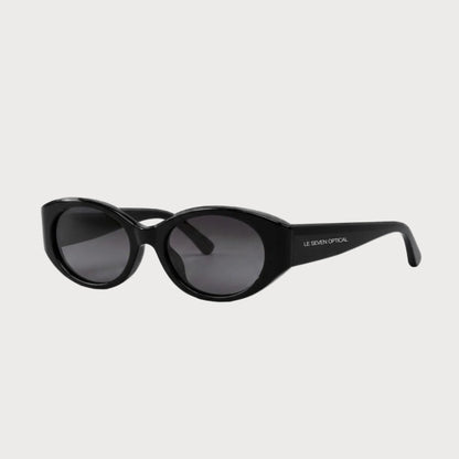 Bella Black oval polarized sunglasses, three-quarter front-side product view on light gray