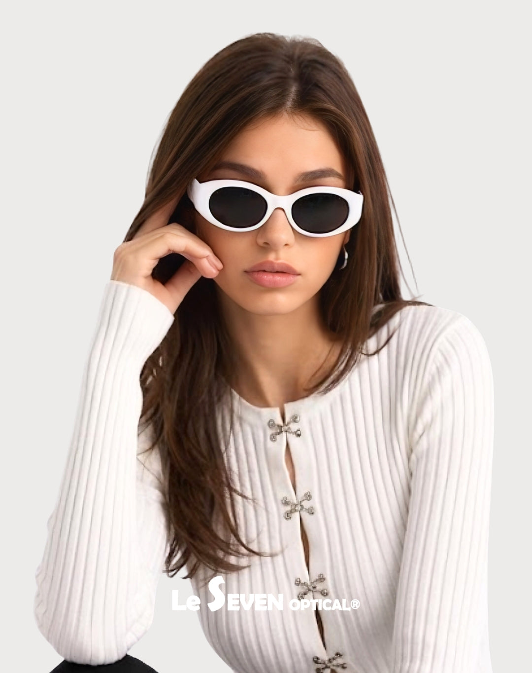 Model wearing Bella White oval polarized sunglasses, front portrait