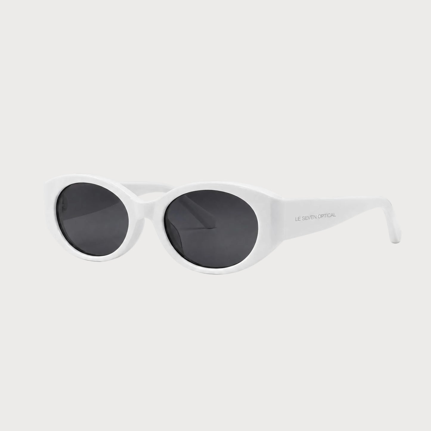 Bella White oval polarized sunglasses, three-quarter front-side product view on light gray