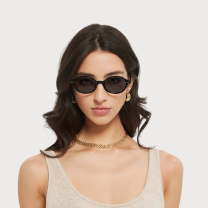 Model wearing Isla Black oval sunglasses
