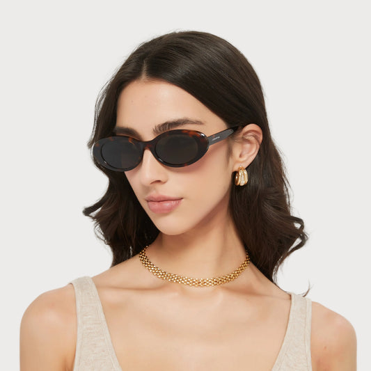 Model wearing Jade Brown Tortoise oval sunglasses, angled view