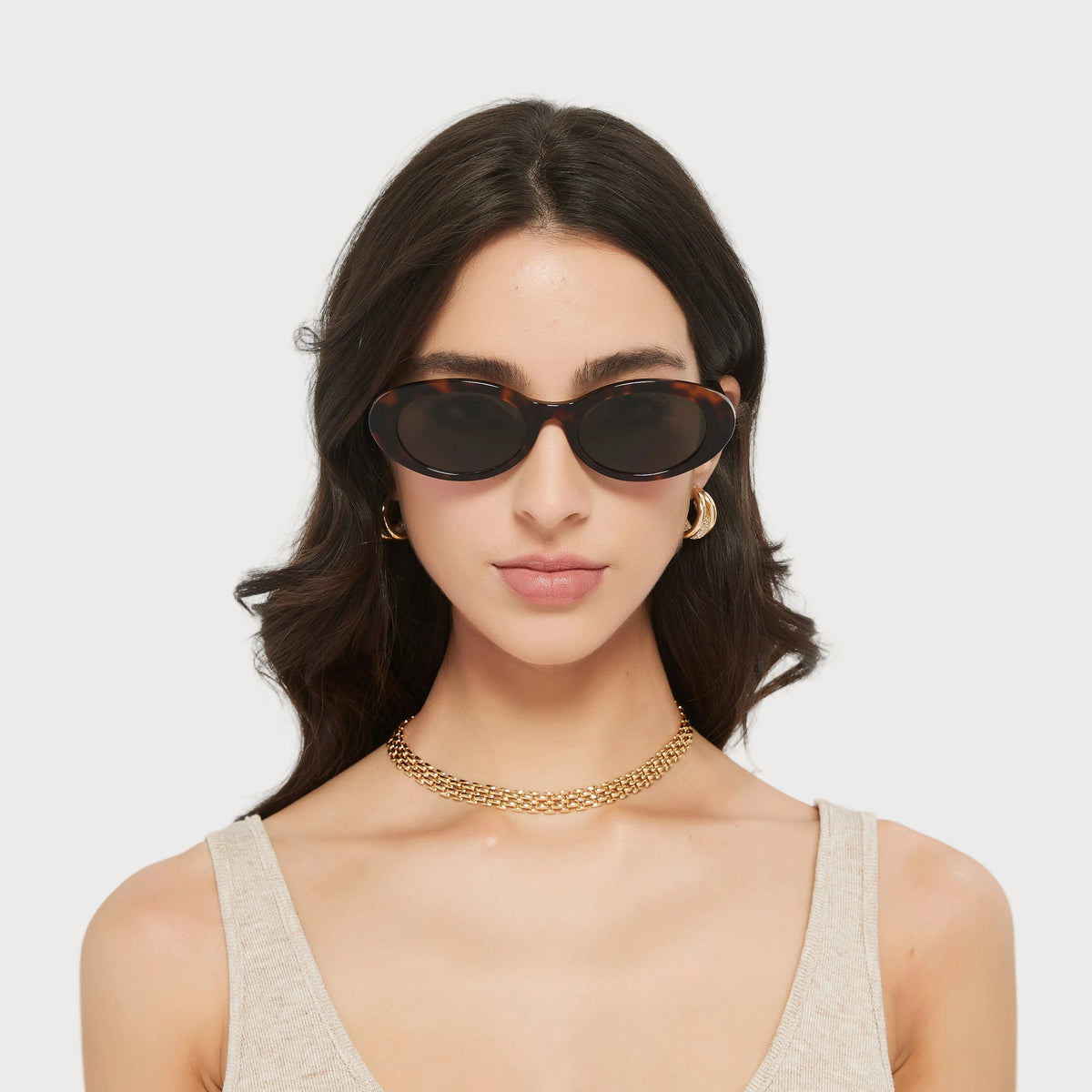 Model wearing Jade Brown Tortoise oval sunglasses, front view