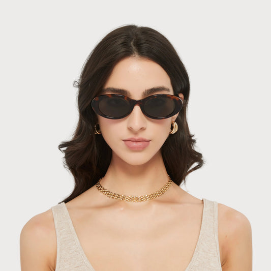 Model wearing Jade Brown Tortoise oval sunglasses, front view