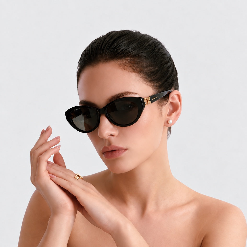 Model wearing Mira Black sunglasses, square portrait on a light gray background.