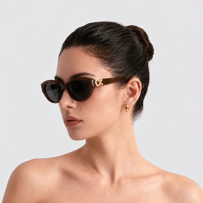 Model wearing Mira Brown sunglasses, square portrait on a light gray background.
