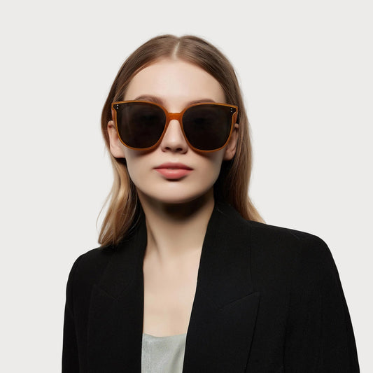 Model wearing Amara Brown square non-polarized sunglasses, front view